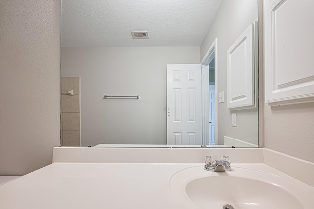 1219 Newsome Glenn Dr, Houston, TX 77090 - bathroom with a textured ceiling and vanity