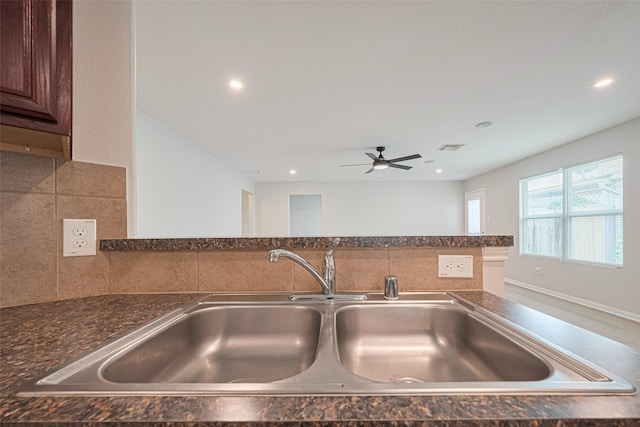 1219 Newsome Glenn Dr, Houston, TX 77090 - kitchen view of a sink, tasteful backsplash, ceiling fan, recessed lighting, and dark brown cabinets
