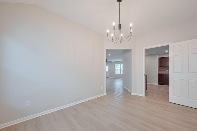 1219 Newsome Glenn Dr, Houston, TX 77090 - empty room with a chandelier, light wood-type flooring, baseboards, and lofted ceiling