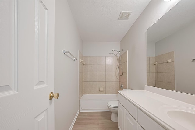1219 Newsome Glenn Dr, Houston, TX 77090 - full bath featuring vanity, wood finished floors, shower / bathtub combination, toilet, and a textured ceiling