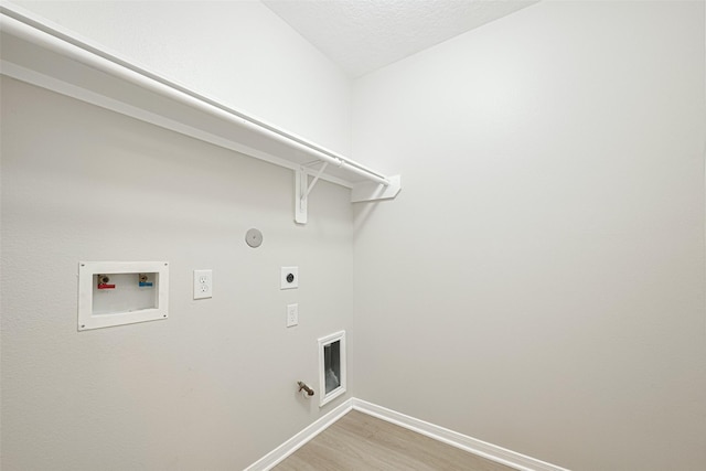 1219 Newsome Glenn Dr, Houston, TX 77090 - laundry room with gas dryer hookup, hookup for an electric dryer, washer hookup, light wood finished floors, and baseboards