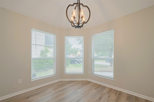 1219 Newsome Glenn Dr, Houston, TX 77090 - unfurnished dining area featuring light wood-style flooring, a chandelier, and baseboards