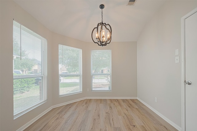 1219 Newsome Glenn Dr, Houston, TX 77090 - unfurnished room with light wood-type flooring, a chandelier, and baseboards