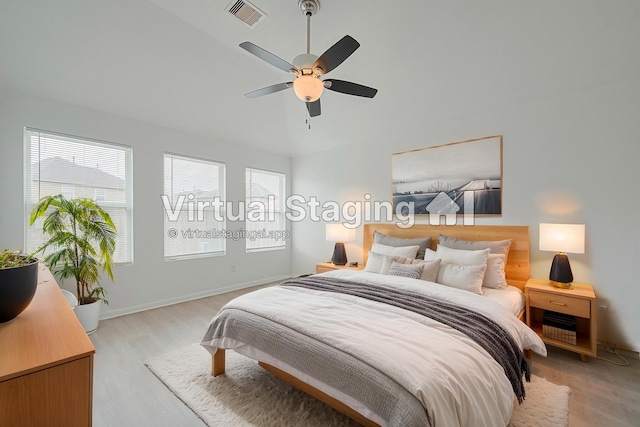 1219 Newsome Glenn Dr, Houston, TX 77090 - bedroom featuring light wood-style flooring, vaulted ceiling, baseboards, and ceiling fan