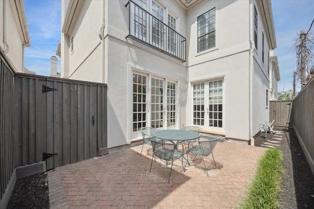2214 Potomac Dr Unit 2, Houston, TX 77057 - fenced backyard featuring french doors, a patio, and outdoor dining area
