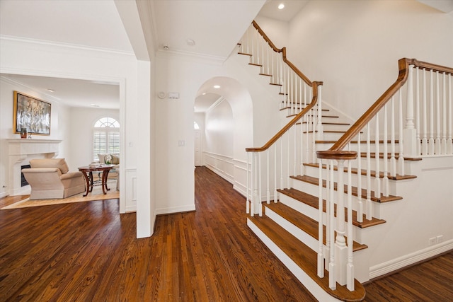 2214 Potomac Dr Unit 2, Houston, TX 77057 - stairway with arched walkways, wood finished floors, crown molding, recessed lighting, and a fireplace