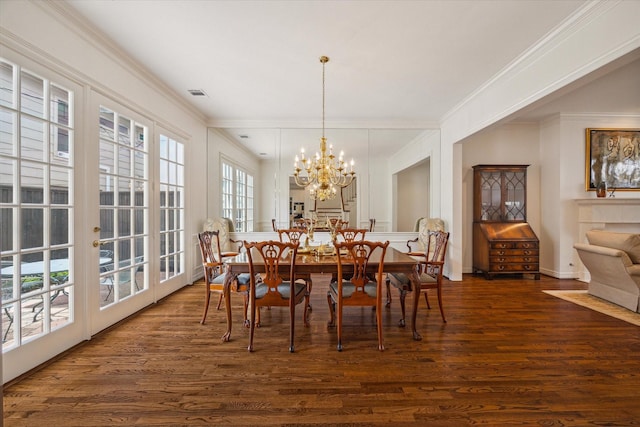 2214 Potomac Dr Unit 2, Houston, TX 77057 - dining area with dark wood-style flooring, crown molding, a chandelier, and baseboards