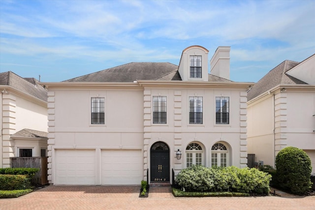 2214 Potomac Dr Unit 2, Houston, TX 77057 - view of front facade with decorative driveway, a garage, and stucco siding