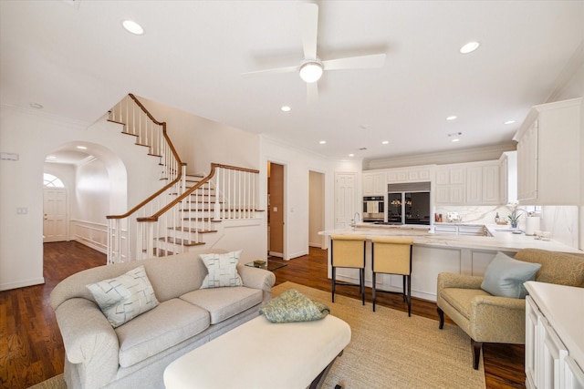 2214 Potomac Dr Unit 2, Houston, TX 77057 - living room featuring arched walkways, stairway, crown molding, dark wood-style flooring, and ceiling fan
