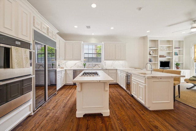 2214 Potomac Dr Unit 2, Houston, TX 77057 - kitchen featuring a peninsula, a kitchen breakfast bar, open floor plan, appliances with stainless steel finishes, and beverage cooler