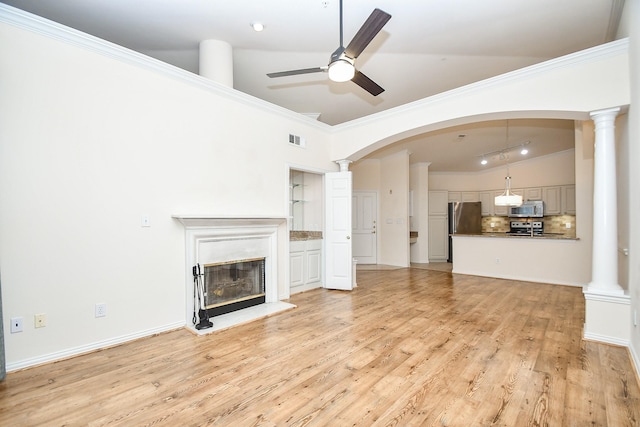 2100 Welch St Unit C305, Houston, TX 77019 - unfurnished living room with a ceiling fan, light wood finished floors, a glass covered fireplace, decorative columns, and ornamental molding