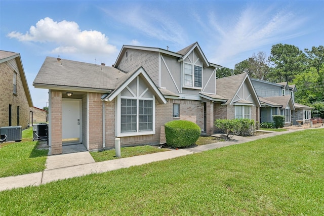 2079 Country Village Blvd Unit C, Humble, TX 77338 - view of front of home with central AC, a front yard, and brick siding