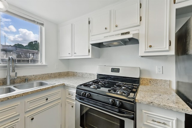 2079 Country Village Blvd Unit C, Humble, TX 77338 - kitchen featuring gas range, under cabinet range hood, a sink, and white cabinets