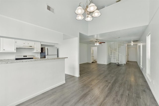 2079 Country Village Blvd Unit C, Humble, TX 77338 - unfurnished living room featuring a high ceiling, stairway, dark wood-type flooring, a chandelier, and baseboards