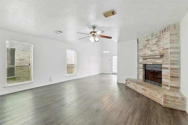 2079 Country Village Blvd Unit C, Humble, TX 77338 - unfurnished living room with ceiling fan, a brick fireplace, wood finished floors, a textured ceiling, and vaulted ceiling