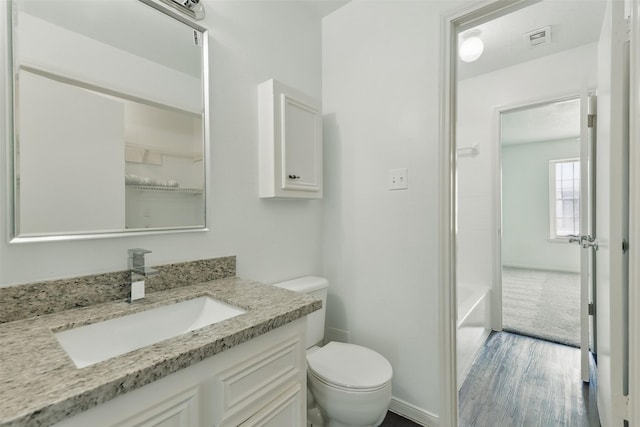 2079 Country Village Blvd Unit C, Humble, TX 77338 - bathroom with toilet, vanity, wood finished floors, baseboards, and a bathtub