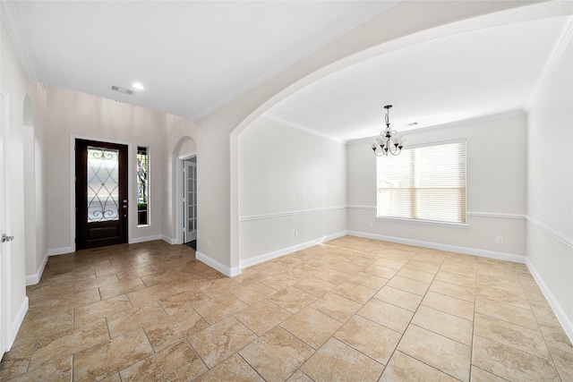 27910 Wedgeoak Ct, Katy, TX 77494 - foyer with a chandelier, arched walkways, stone tile flooring, crown molding, and baseboards