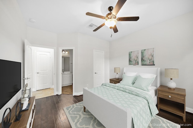 27910 Wedgeoak Ct, Katy, TX 77494 - bedroom with dark wood-style flooring, baseboards, ensuite bathroom, and ceiling fan