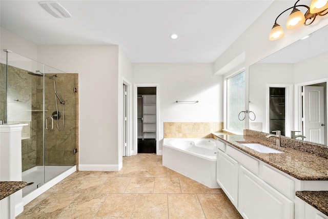 27910 Wedgeoak Ct, Katy, TX 77494 - full bath featuring a shower stall, a tub with jets, a walk in closet, vanity, and baseboards