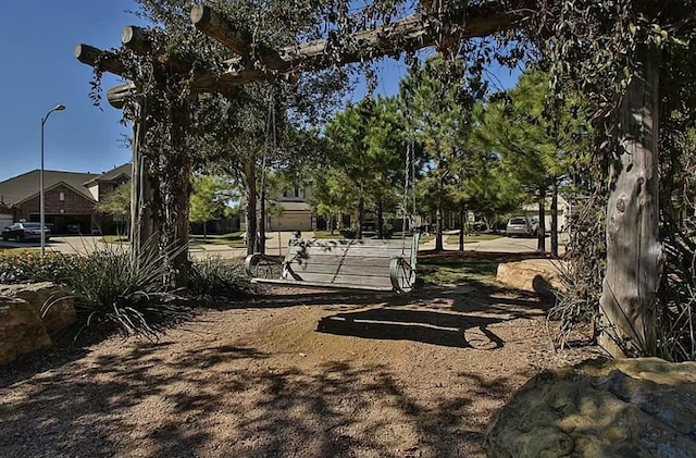 27910 Wedgeoak Ct, Katy, TX 77494 - view of dirt / gravel driveway with street lighting