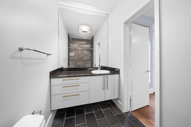 1822 Brun St, Houston, TX 77019 - bathroom featuring vanity, a tile shower, and toilet