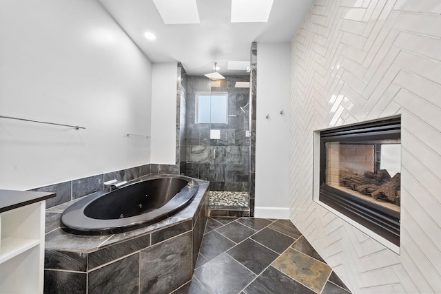 1822 Brun St, Houston, TX 77019 - bathroom with a whirlpool tub, a shower stall, a multi sided fireplace, a skylight, and recessed lighting