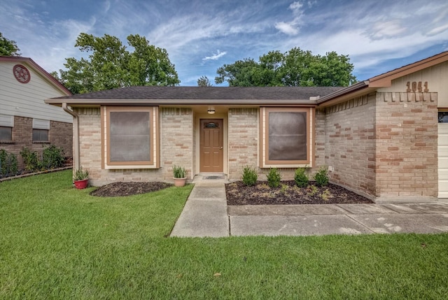1041 Crossing Rd, Angleton, TX 77515 - ranch-style home with a front lawn, brick siding, and a shingled roof