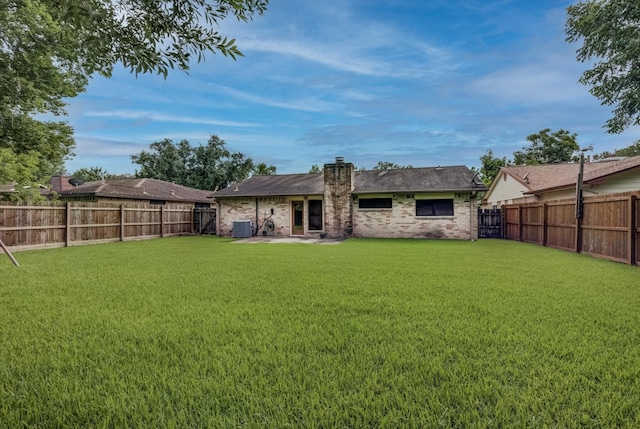1041 Crossing Rd, Angleton, TX 77515 - rear view of house featuring a chimney, a fenced backyard, and brick siding