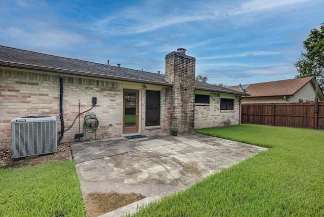 1041 Crossing Rd, Angleton, TX 77515 - back of property with a chimney, a patio area, brick siding, and a shingled roof