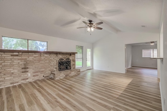 1041 Crossing Rd, Angleton, TX 77515 - unfurnished living room with ceiling fan, wood finished floors, a textured ceiling, and a fireplace