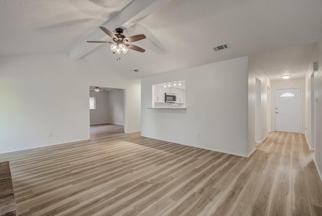 1041 Crossing Rd, Angleton, TX 77515 - unfurnished living room featuring ceiling fan, a textured ceiling, and light wood-style flooring