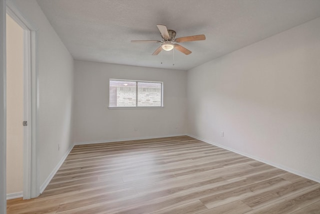 1041 Crossing Rd, Angleton, TX 77515 - empty room with light wood-style flooring, a ceiling fan, and a textured ceiling