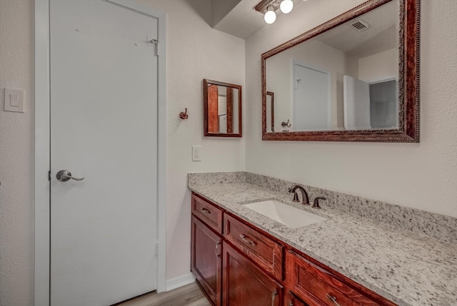 1041 Crossing Rd, Angleton, TX 77515 - bathroom with vanity and wood finished floors