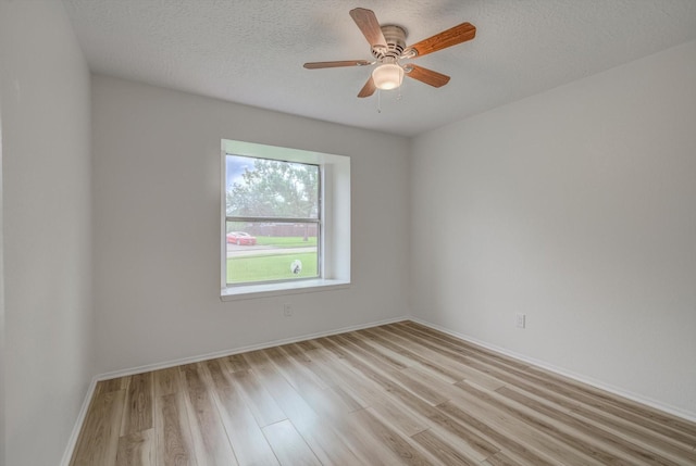1041 Crossing Rd, Angleton, TX 77515 - empty room featuring light wood-style floors, ceiling fan, and a textured ceiling