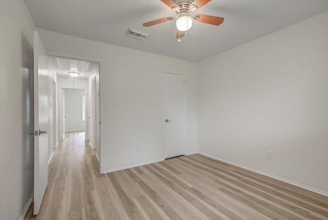 1041 Crossing Rd, Angleton, TX 77515 - unfurnished bedroom featuring attic access, light wood-type flooring, and a ceiling fan