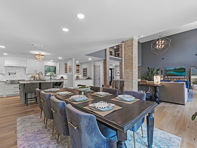 15722 Island Grove Ct, Houston, TX 77079 - dining room with light wood-style floors, a chandelier, and recessed lighting