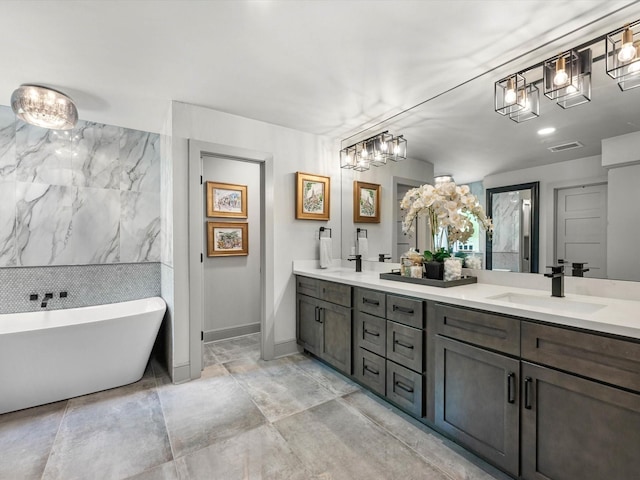 15722 Island Grove Ct, Houston, TX 77079 - bathroom with double vanity, a freestanding bath, and a chandelier