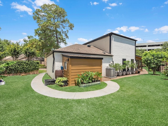 15722 Island Grove Ct, Houston, TX 77079 - rear view of house featuring a garage, brick siding, and central AC
