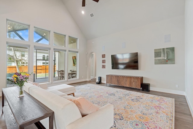 5807 Yango Terrace Ln, Sugar Land, TX 77479 - living area with high vaulted ceiling, ceiling fan, baseboards, wood finished floors, and arched walkways