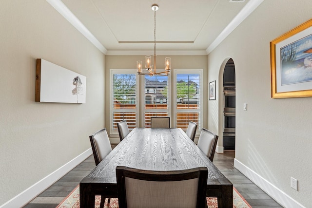 5807 Yango Terrace Ln, Sugar Land, TX 77479 - dining area with dark wood-style flooring, a chandelier, baseboards, arched walkways, and ornamental molding