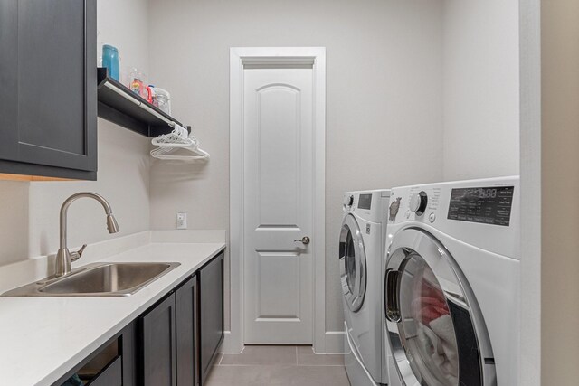 5807 Yango Terrace Ln, Sugar Land, TX 77479 - laundry room featuring cabinet space, washer and clothes dryer, and light tile patterned floors