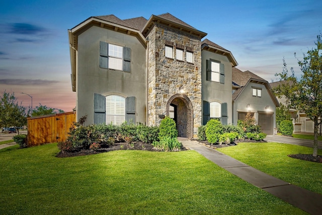 5807 Yango Terrace Ln, Sugar Land, TX 77479 - view of front of house with stone siding, stucco siding, a front lawn, and a shingled roof