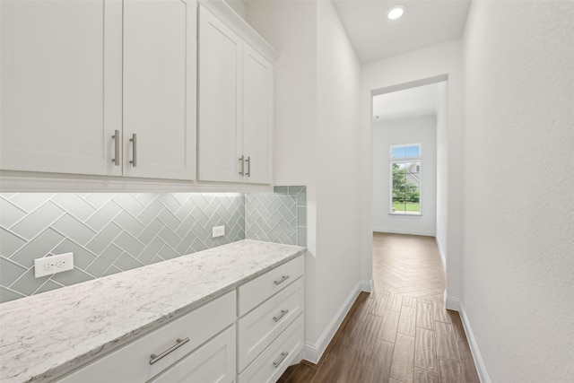25306 Hollowgate Park Ln, Tomball, TX 77375 - kitchen featuring baseboards, tasteful backsplash, white cabinets, light stone countertops, and recessed lighting