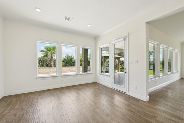 25306 Hollowgate Park Ln, Tomball, TX 77375 - unfurnished room with plenty of natural light, wood finished floors, baseboards, recessed lighting, and crown molding