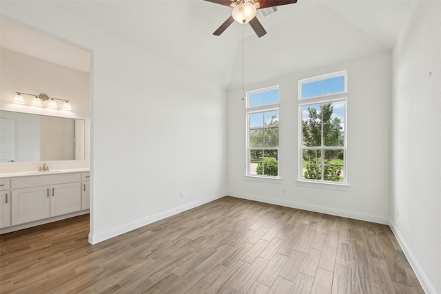 25306 Hollowgate Park Ln, Tomball, TX 77375 - unfurnished room featuring a sink, a ceiling fan, light wood-type flooring, baseboards, and high vaulted ceiling