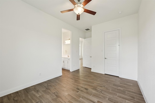 25306 Hollowgate Park Ln, Tomball, TX 77375 - unfurnished bedroom featuring wood finished floors, baseboards, ensuite bath, and a ceiling fan