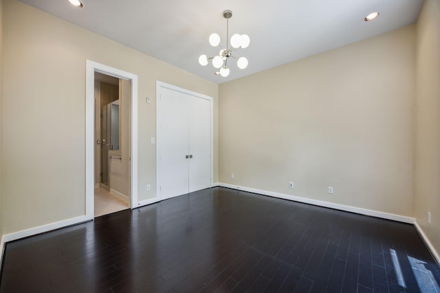 207 Pierce St Unit 205, Houston, TX 77002 - unfurnished room featuring a chandelier, wood finished floors, baseboards, and recessed lighting