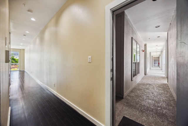 207 Pierce St Unit 205, Houston, TX 77002 - hall featuring baseboards, recessed lighting, and dark wood-type flooring