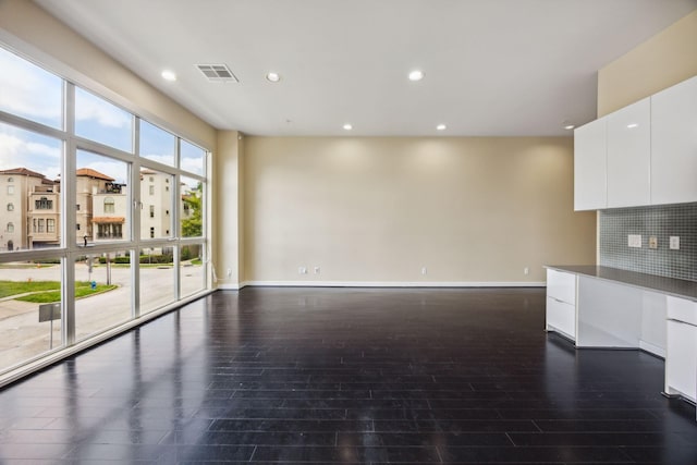 207 Pierce St Unit 205, Houston, TX 77002 - unfurnished living room featuring dark wood finished floors, recessed lighting, and baseboards