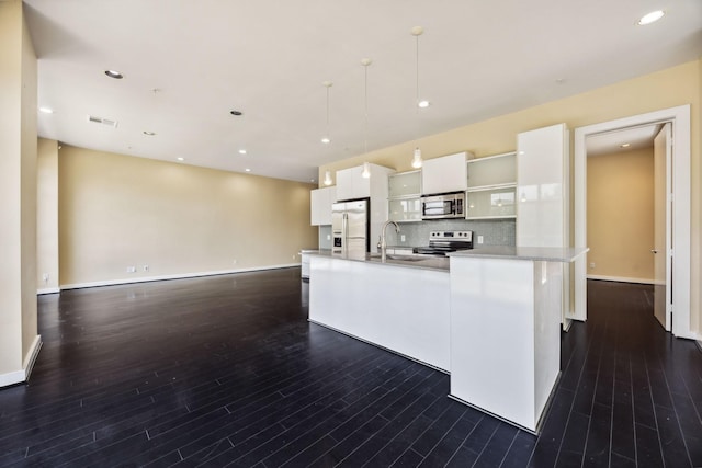 207 Pierce St Unit 205, Houston, TX 77002 - kitchen with stainless steel appliances, a sink, open shelves, white cabinetry, and dark wood-style flooring